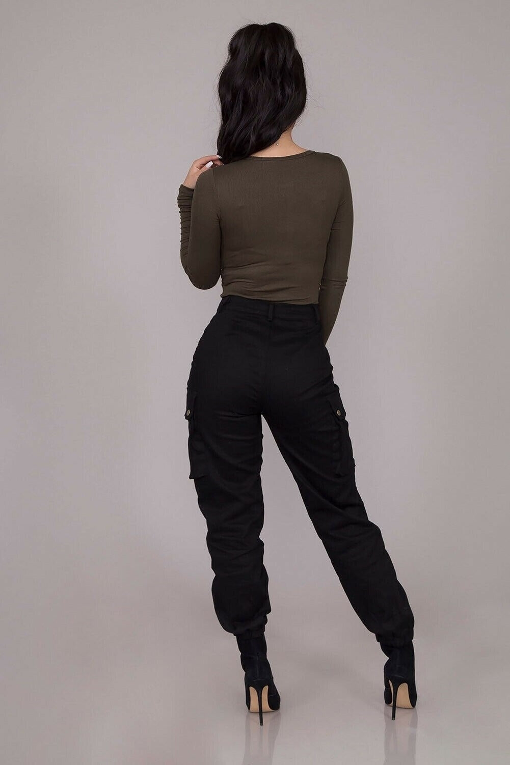 "Upgrade your style with these chic high-waisted black cargo pants featuring button pockets and a gothic twist. These solid color, long trousers are perfect for all sizes. Get yours now!"